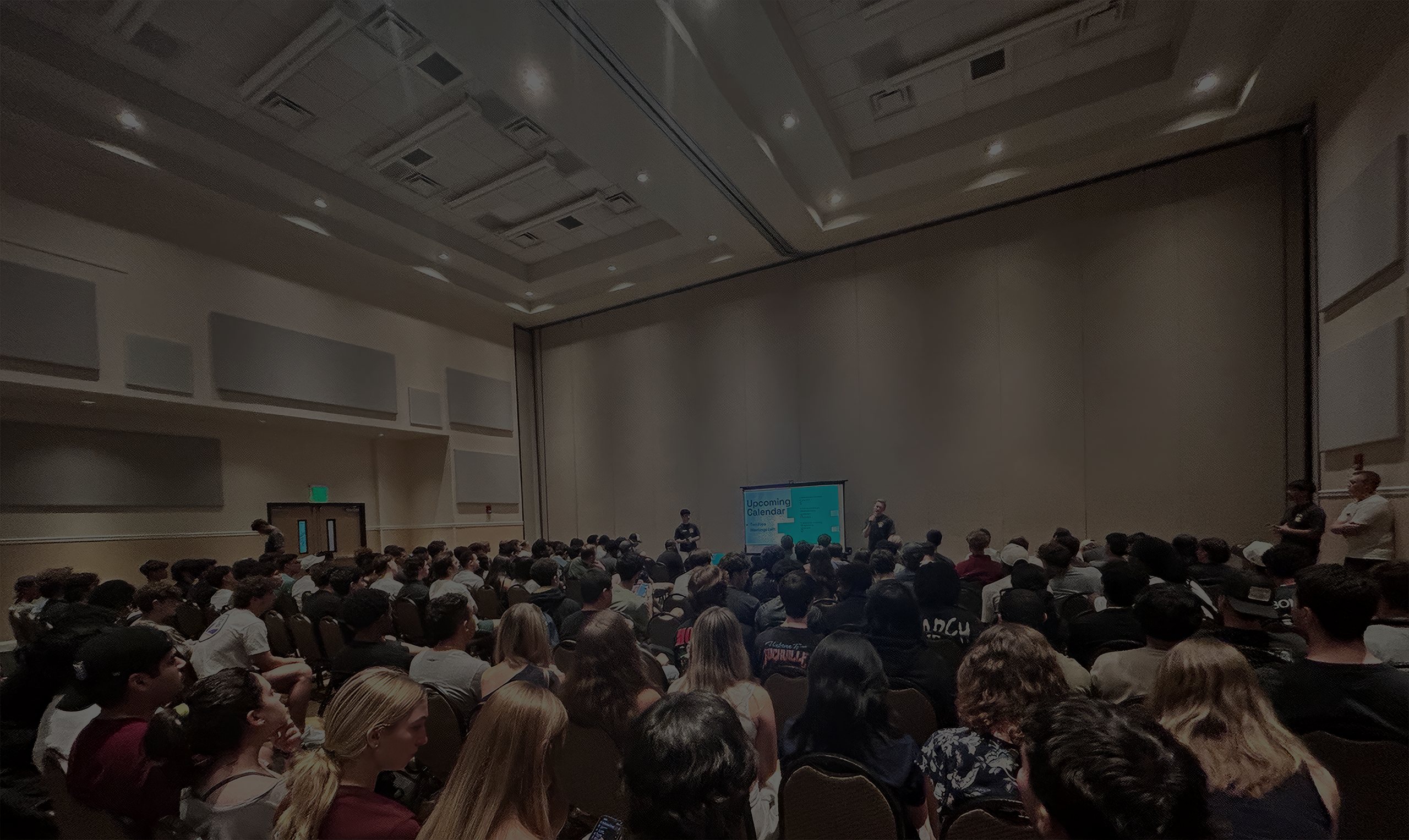 Young Investors Club general body meeting — a packed UCF ballroom